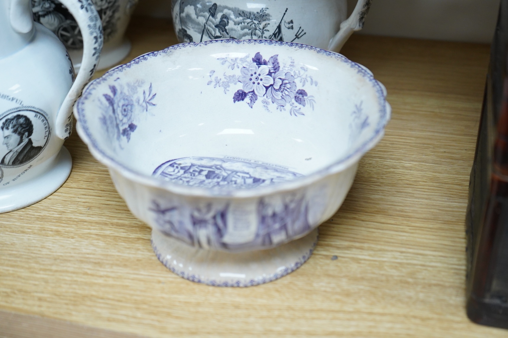 Six contemporary political themed earthenware pottery jugs and a pedestal bowl commemorating the 1832 Reform Bill, with transfer printed symbolic scenes of the Houses of Parliament, details regarding the voting, portrait